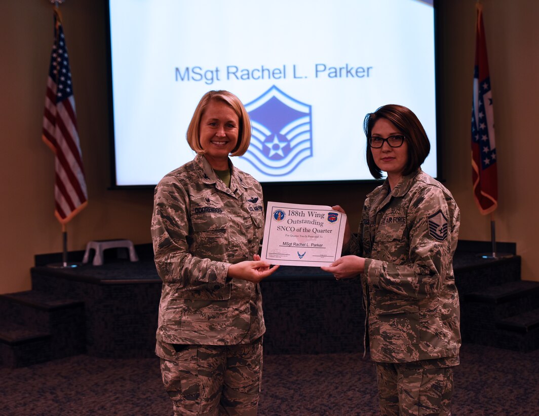 Master Sgt. Rachel Parker, 188th Intelligence, Surveillance and Reconnaissance Group training manager, accepts the Outstanding Senior Noncommissioned Officer of the Quarter award from Col. Bobbi Doorenbos, 188th Wing commander, May 15, 2016, during a commander’s call at Ebbing Air National Guard Base, Fort Smith, Ark. The Outstanding Airman of the Quarter award is given to Airmen that have provided exceptional service to the wing throughout the last quarter and distinguished themselves among the best in the 188th. Winners were selected in the Airman, NCO, Senior NCO, Company Grade Officer and Field Grade Officer categories. (U.S. Air National Guard photo by Senior Airman Cody Martin/Released)