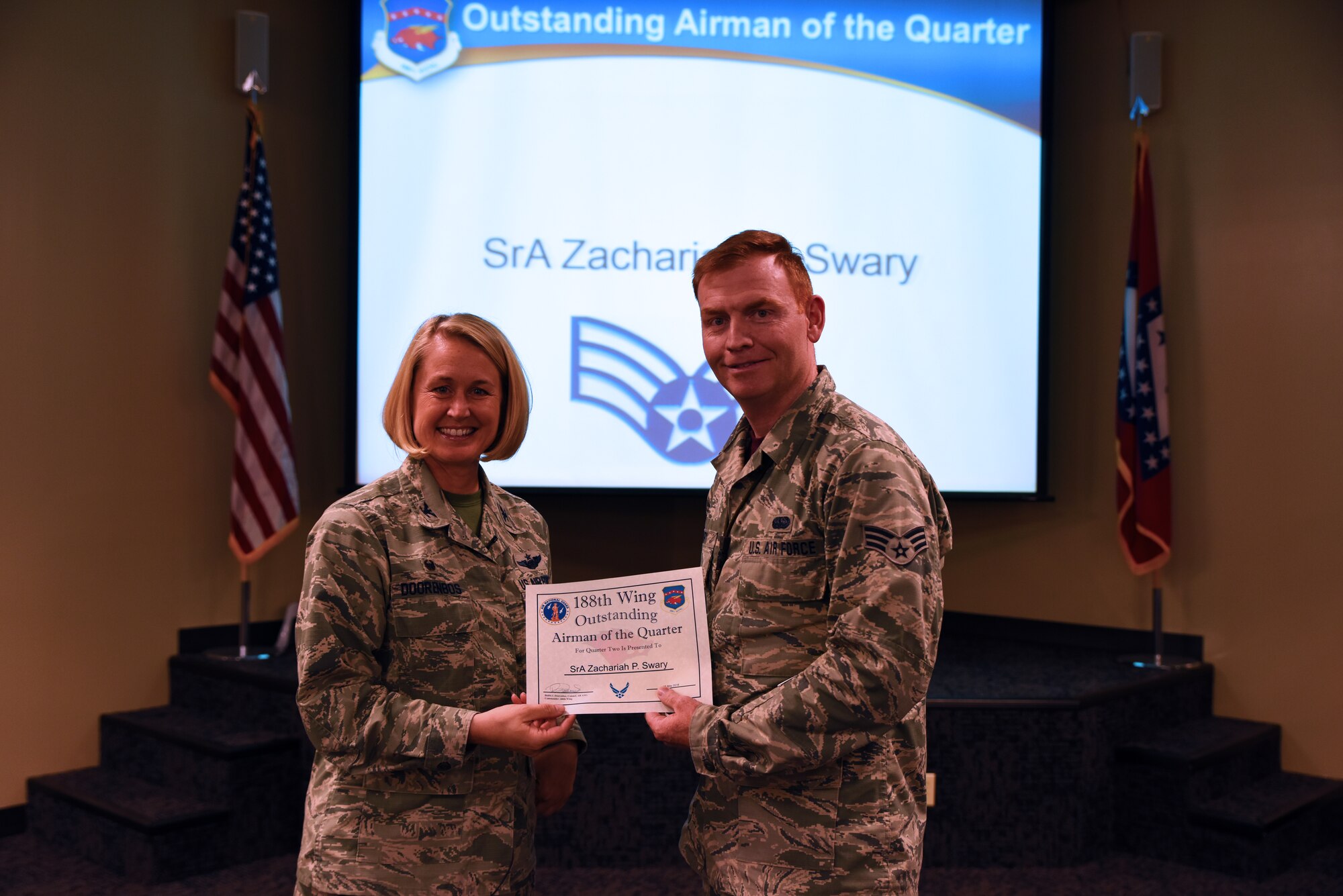 Senior Airman Zachariah P. Swary, cyber systems operator, accepts the Outstanding Airman of the Quarter award from Col. Bobbi Doorenbos, 188th Wing commander, May 15, 2016, during a commander’s call at Ebbing Air National Guard Base, Fort Smith, Ark. The Outstanding Airman of the Quarter award is given to Airmen that have provided exceptional service to the wing throughout the last quarter and distinguished themselves among the best in the 188th. Winners were selected in the Airman, Noncommissioned Officer, Senior NCO, Company Grade Officer and Field Grade Officer categories. (U.S. Air National Guard photo by Senior Airman Cody Martin/Released)