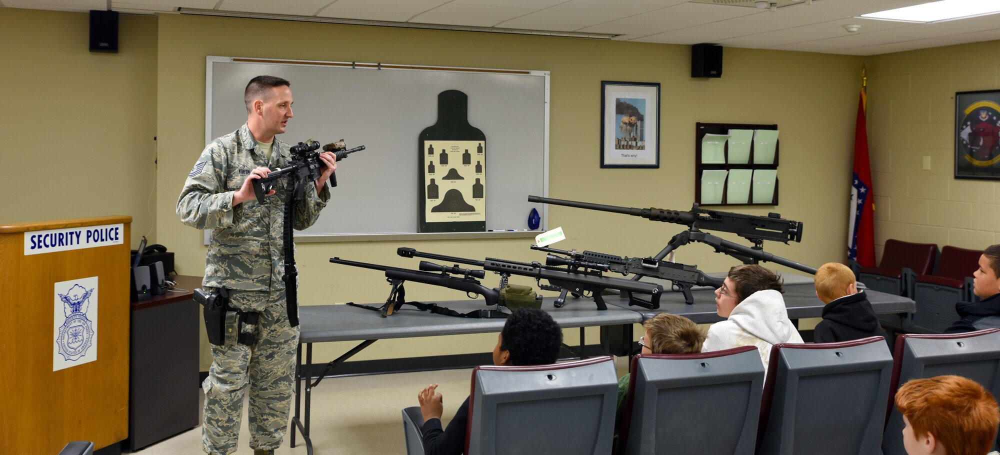 Tech. Sgt. Frank Koeth, 188th Security Forces Squadron training instructor, teaches students from Fort Smith Sutton Elementary School about a potential career as a member of 188th SFS May 3, 2016, during a tour at the 188th Wing with their mentors at Ebbing Air National Guard Base, Fort Smith, Ark., as part of the mentorship program. The 188th Wing has partnered with schools in the local community to provide mentors to children within the program. The program is designed to enhance the presence of positive role models in children’s lives. (U.S. Air National Guard photo by Senior Airman Cody Martin/Released)