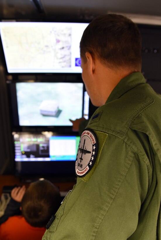 Students from Fort Smith Sutton Elementary School sit in an MQ-9 Reaper simulator May 3, 2016, during their tour of the 188th Wing with their mentors at Ebbing Air National Guard Base, Fort Smith, Ark., as part of the Partners in Education mentorship program. The 188th Wing has partnered with schools in the local community to provide mentors to children within the program. The program is designed to enhance the presence of positive role models in children’s lives. (U.S. Air National Guard photo by Senior Airman Cody Martin/Released)