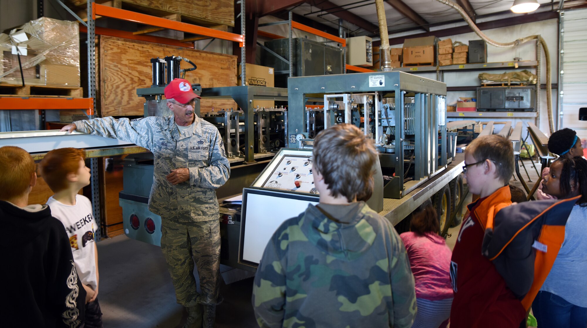 Senior Master Sgt. Robert Haag II, Rapid Deployable Heavy Operational Repair Engineer (REDHORSE) training center senior instructor, shows students from Fort Smith Sutton Elementary School the metal bending machine May 3, 2016, during their tour of the 188th Wing with their mentors at Ebbing Air National Guard Base, Fort Smith, Ark., as part of the mentorship program. The 188th Wing has partnered with schools in the local community to provide mentors to children within the program. The program is designed to enhance the presence of positive role models in children’s lives. (U.S. Air National Guard photo by Senior Airman Cody Martin/Released)