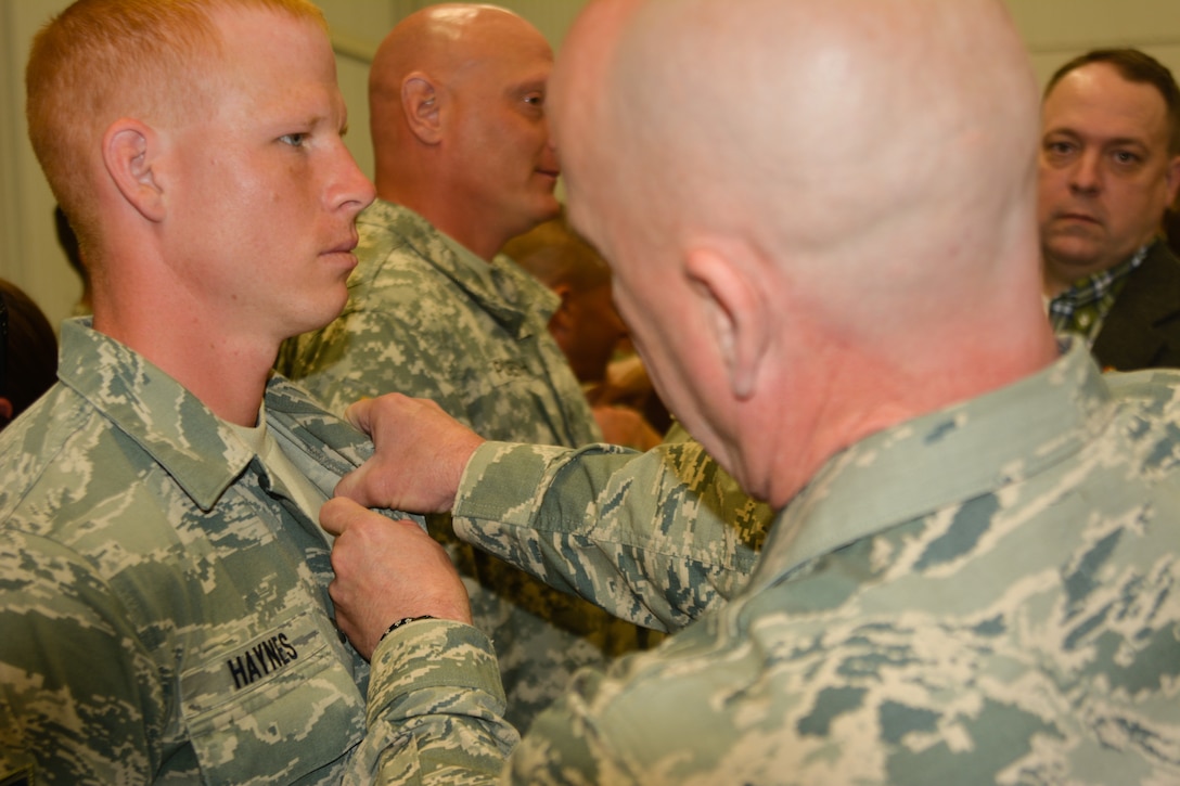 U.S. Air Force Staff Sgt. Greggory Haynes, assigned to the 139th Security Forces Squadron, Missouri Air National Guard, receives the Air Assault Badge at Camp Crowder in Neosho, Mo., May 13, 2016. Haynes and Tech. Sgt. Kristen Roles were the first airmen from the 139th Airlift Wing to compete in the Army Air Assault Course. (U.S. Air National Guard photo by Senior Master Sgt. Jeffery Dunning/released)