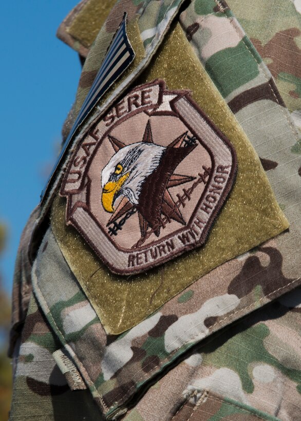 U.S. Air Force Tech. Sgt. Estiven Gonzales, 7th Operations Support Squadron Survival Evasion Resistance Escape specialist, wears a SERE patch on his uniform during a combat survival course training Feb. 18, 2016, in Abilene, Texas. “Return With Honor,” is the motto of SERE specialists, whose duty is to teach those with a high risk of capture and isolation how to return home with honor from any type of survival situation. (U.S. Air Force photo by Airman 1st Class Katherine Miller/Released)