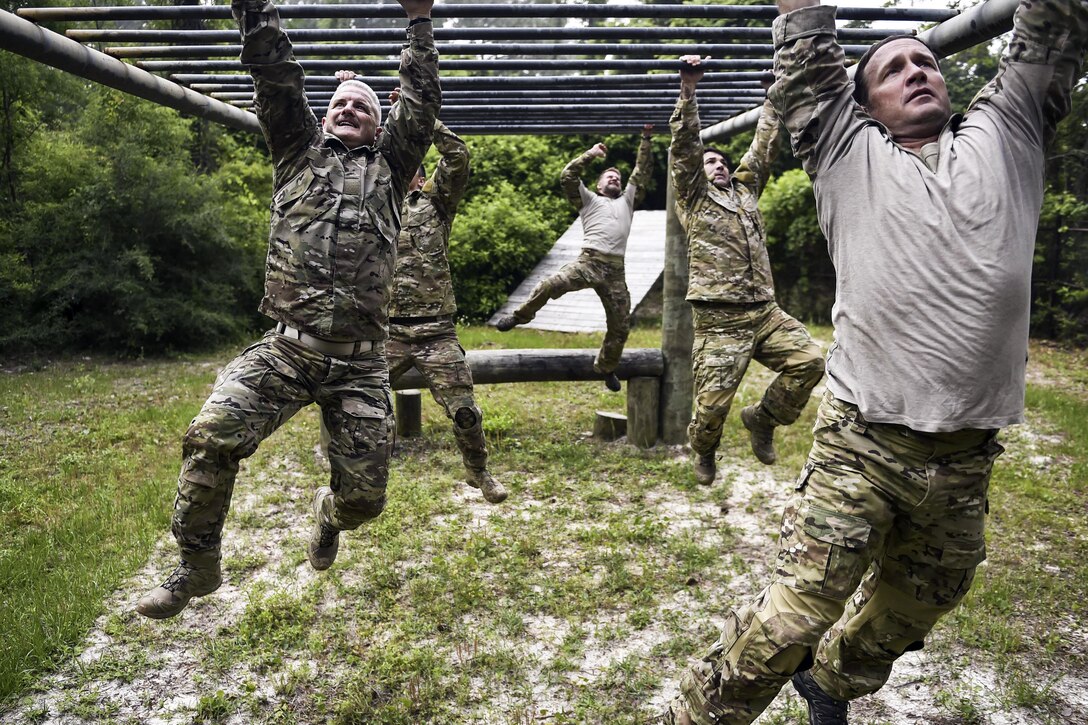Airmen on Monster Mash Team 4 complete a monkey-bar obstacle  at Hurlburt Field, Fla., May 12, 2016. Monster Mash is a training tradition in which special operators complete timed scenarios on an obstacle course. Air Force photo by Senior Airman Ryan Conroy