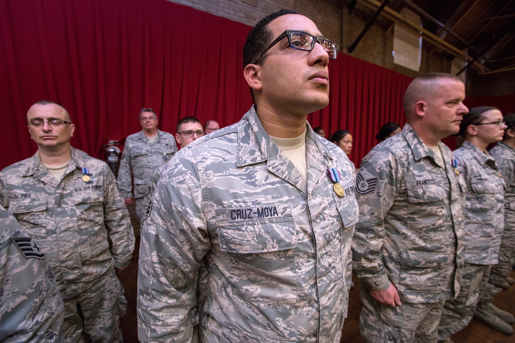 Senior Airman Willie Cruz-Moya, 108th Wing, along with 108th and 177th Fighter Wing Airmen stand at attention after receiving the Humanitarian Service Medal at an awards ceremony at the National Guard Armory in Lawrenceville, N.J., May 3, 2016. (U.S. Air National Guard photo by Master Sgt. Mark C. Olsen/Released)