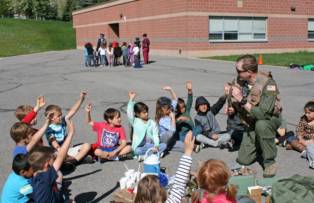 Air Force Maj. TJ Eaton, a pilot with the 151st Operations Group, visits a
local elementary school on May 18 in honor of Armed Forces Day. Eaton showed
a group of more than 50 children various Air Force life support equipment,
and spoke about honoring those who serve in the military. In addition,
Reserve Officer Training Corps cadets from the University of Utah (as seen
in the background) demonstrated ceremonial flag folding procedures, offering
the children a hands-on opportunity to practice the procedures themselves.
(U.S. Air National Guard photo by Maj. Jennifer Eaton/Released)
