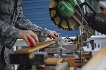 Tech. Sgt. Michael Ventura, 512th Civil Engineer Squadron, measures flooring prior to cutting in downtown Dover, Del., May 22, 2016, alongside the nonprofit Habitat for Humanity to provide housing forindividuals and families in need. The house build is able to satisfy certain training requirements needed for 512th CE Airmen while also providing a real-world benifit to families in the local community. (U.S. Air Force photo/Capt. Bernie Kale)