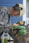 Tech. Sgt. Michael Ventura cuts flooring during a Habitat for Humanity home construction build in downtown Dover, Del., May 22, 2016, to provide housing forindividuals and families in need. The house build is able to satisfy certain training requirements needed for 512th CE Airmen while also providing a real-world benifit to families in the local community. (U.S. Air Force photo/Capt. Bernie Kale)