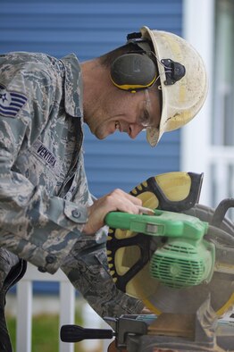 Tech. Sgt. Michael Ventura cuts flooring during a Habitat for Humanity home construction build in downtown Dover, Del., May 22, 2016, to provide housing forindividuals and families in need. The house build is able to satisfy certain training requirements needed for 512th CE Airmen while also providing a real-world benifit to families in the local community. (U.S. Air Force photo/Capt. Bernie Kale)