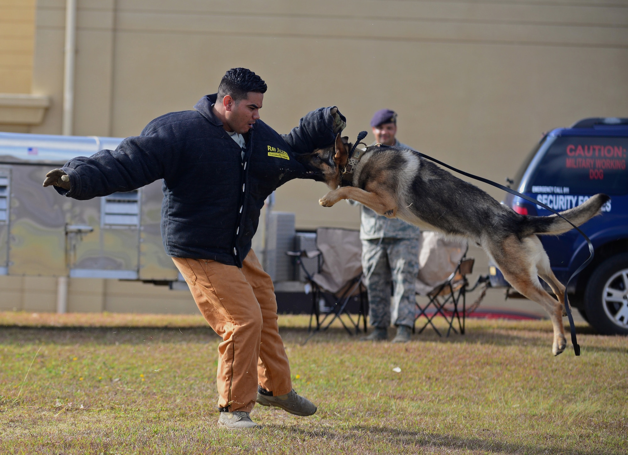 Staff Sgt. Adrian Chavez, 36th Security Forces Squadron military working dog handler, demonstrates how a dog apprehends a perpetrator May 17, 2016, at Andersen Air Force Base, Guam. Airmen from the 36th and 736th Security Forces Squadrons and Air Force Office of Special Investigations Det. 602 displayed their gear and skillsets to Andersen students during Police Week. (U.S. Air Force photo by Senior Airman Joshua Smoot)