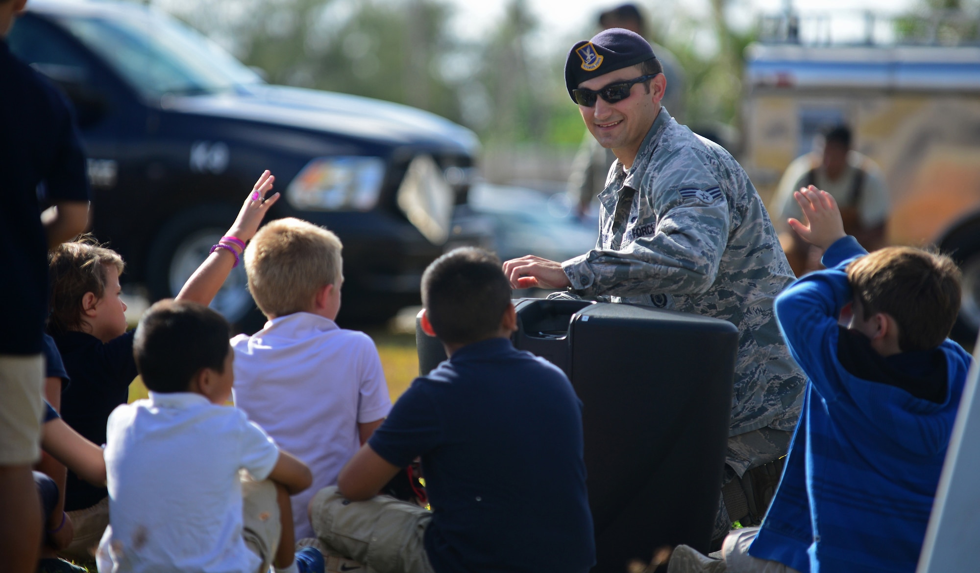 Senior Airman Casey Wheatley, 36th Security Forces Squadron military working dog handler, interacts with students during a MWD demonstration May 17, 2016, at Andersen Air Force Base, Guam. Airmen from the 36th SFS, 736th SFS and Air Force Office of Special Investigations Det. 602 displayed their gear and skillsets to Andersen students. (U.S. Air Force photo by Senior Airman Joshua Smoot)