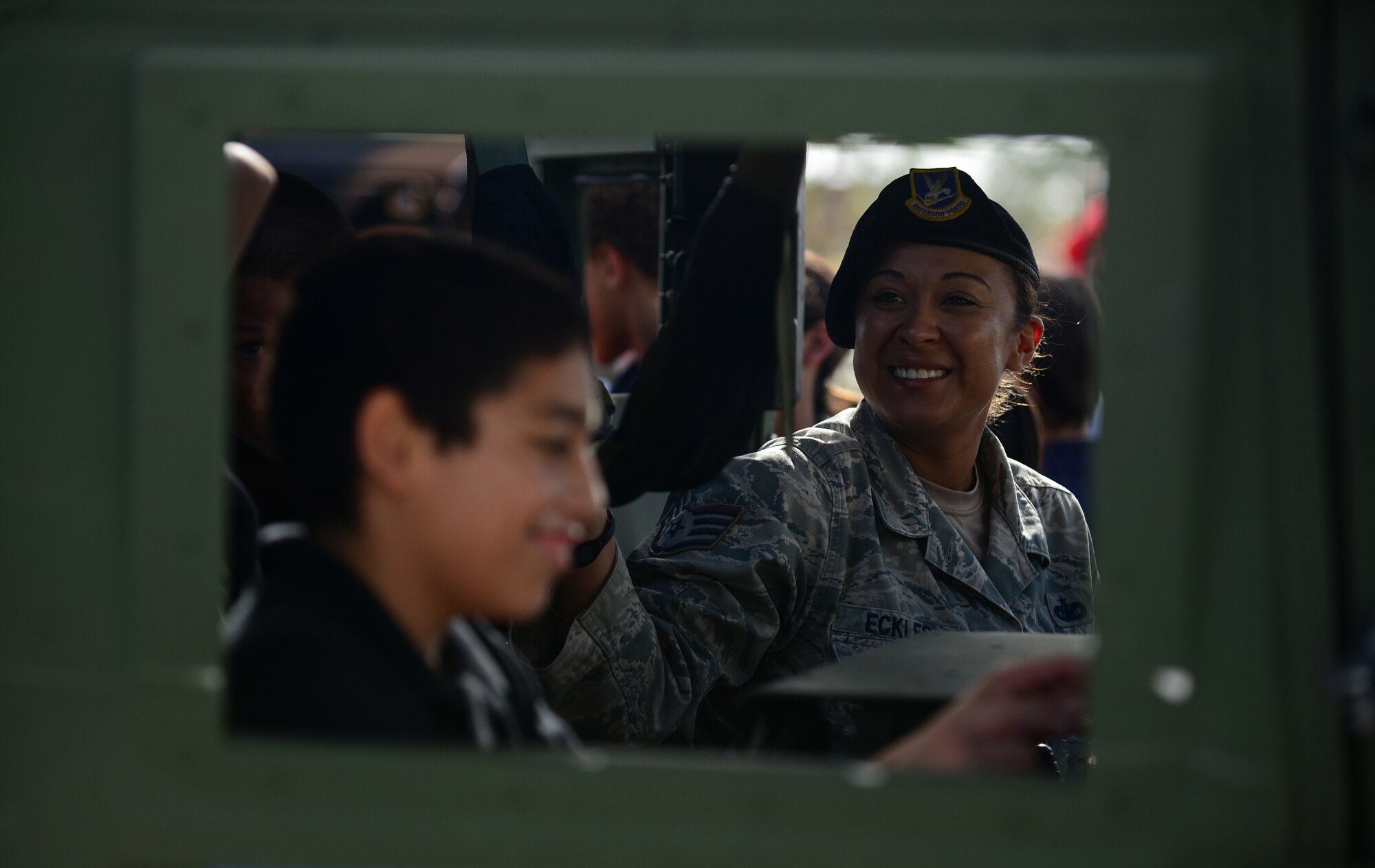 Staff Sgt. Patricia Eckles, 736th Security Forces Squadron Commando Warrior kennel master, interacts with students May 17, 2016, at Andersen Air Force Base, Guam. Airmen from the 36th Security Forces Squadron, 736th SFS and Air Force Office of Special Investigations Det. 602 displayed their gear and skillsets to Andersen students during Police Week. (U.S. Air Force photo by Senior Airman Joshua Smoot)