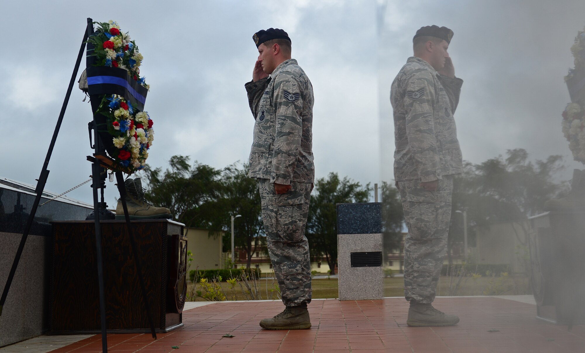 Staff Sgt. Joshua Collins, 36th Security Forces Squadron Emergency Communications Center controller, salutes in front of a symbolic battle cross May 20, 2016, at Andersen Air Force Base, Guam. In honor of Police Week, Airmen paid respect to the fallen with a memorial wreath laying and took turns as vigil guards, similar to the guards at the Tomb of the Unknown Soldier in Arlington, Virginia. (U.S. Air Force photo by Senior Airman Joshua Smoot)