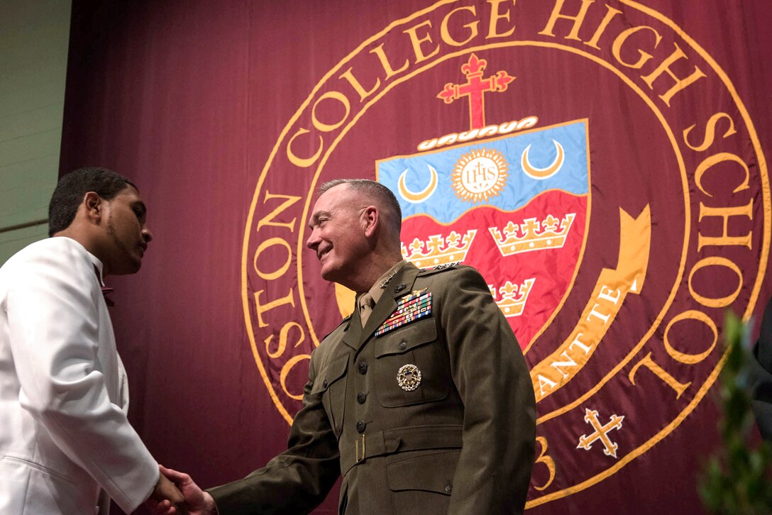 Marine Corps Gen. Joe Dunford, chairman of the Joint Chiefs of Staff, shakes hands with a graduating student of Boston College High School's class of 2016 in Boston, Mass., May 22, 2016. DoD photo by D. Myles Cullen