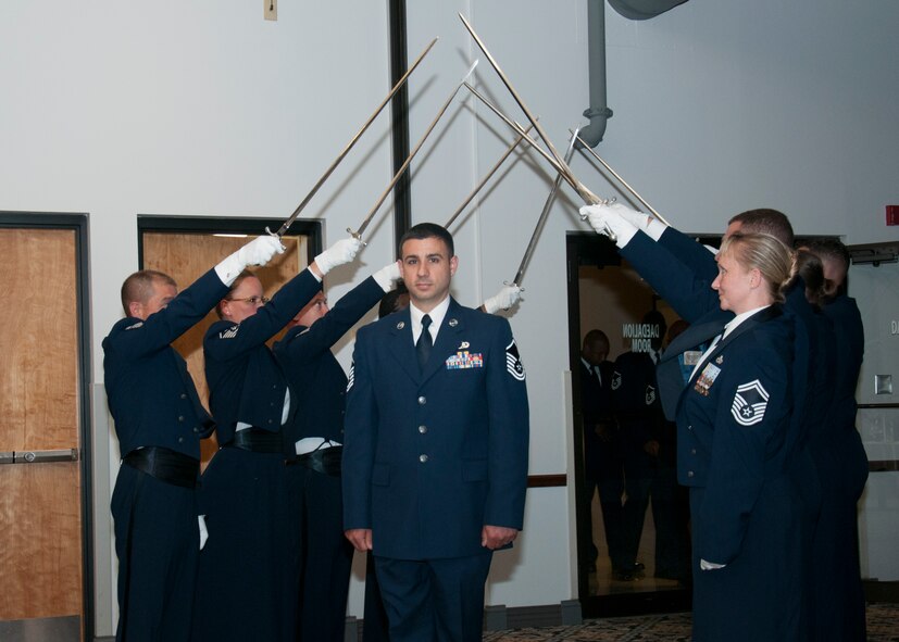 Senior non-commissioned officers with the 512th Airlift Wing, are inducted into the senior enlisted ranks during a ceremony at Dover Air Force Base, Del., May 21, 2016. The event and passing through a sabre arch recognizes the leadership positions the SNCOs now possess as they will lead Airmen in the future. (U.S. Air Force Photo/ Tech. Sgt. Nathan Rivard)