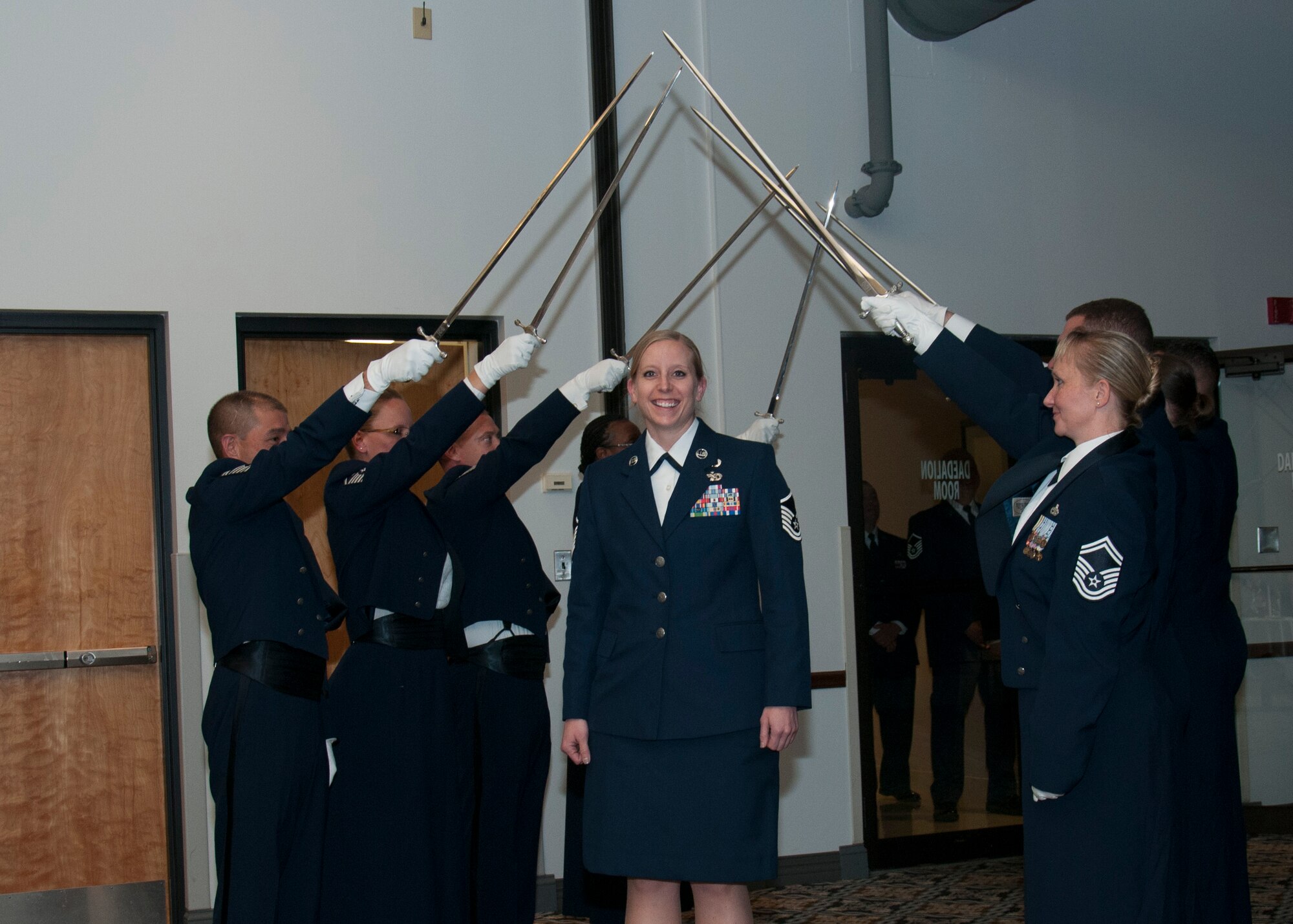 Senior non-commissioned officers with the 512th Airlift Wing, are inducted into the senior enlisted ranks during a ceremony at Dover Air Force Base, Del., May 21, 2016. The event and passing through a sabre arch recognizes the leadership positions the SNCOs now possess as they will lead Airmen in the future. (U.S. Air Force Photo/ Tech. Sgt. Nathan Rivard)