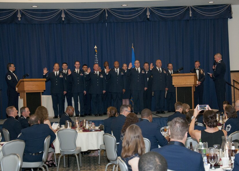 Senior non-commissioned officers with the 512th Airlift Wing, are inducted into the senior enlisted ranks during a ceremony at Dover Air Force Base, Del., May 21, 2016. The event and passing through a sabre arch recognizes the leadership positions the SNCOs now possess as they will lead Airmen in the future. (U.S. Air Force Photo/ Tech. Sgt. Nathan Rivard)