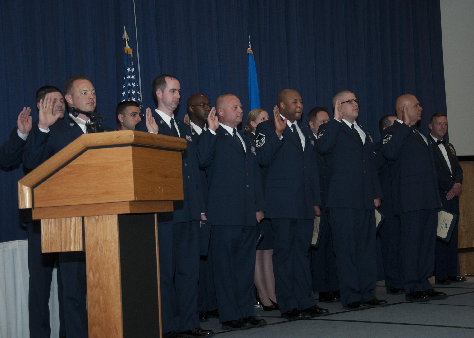 Senior non-commissioned officers with the 512th Airlift Wing, are inducted into the senior enlisted ranks during a ceremony at Dover Air Force Base, Del., May 21, 2016. The event and passing through a sabre arch recognizes the leadership positions the SNCOs now possess as they will lead Airmen in the future. (U.S. Air Force Photo/ Tech. Sgt. Nathan Rivard)