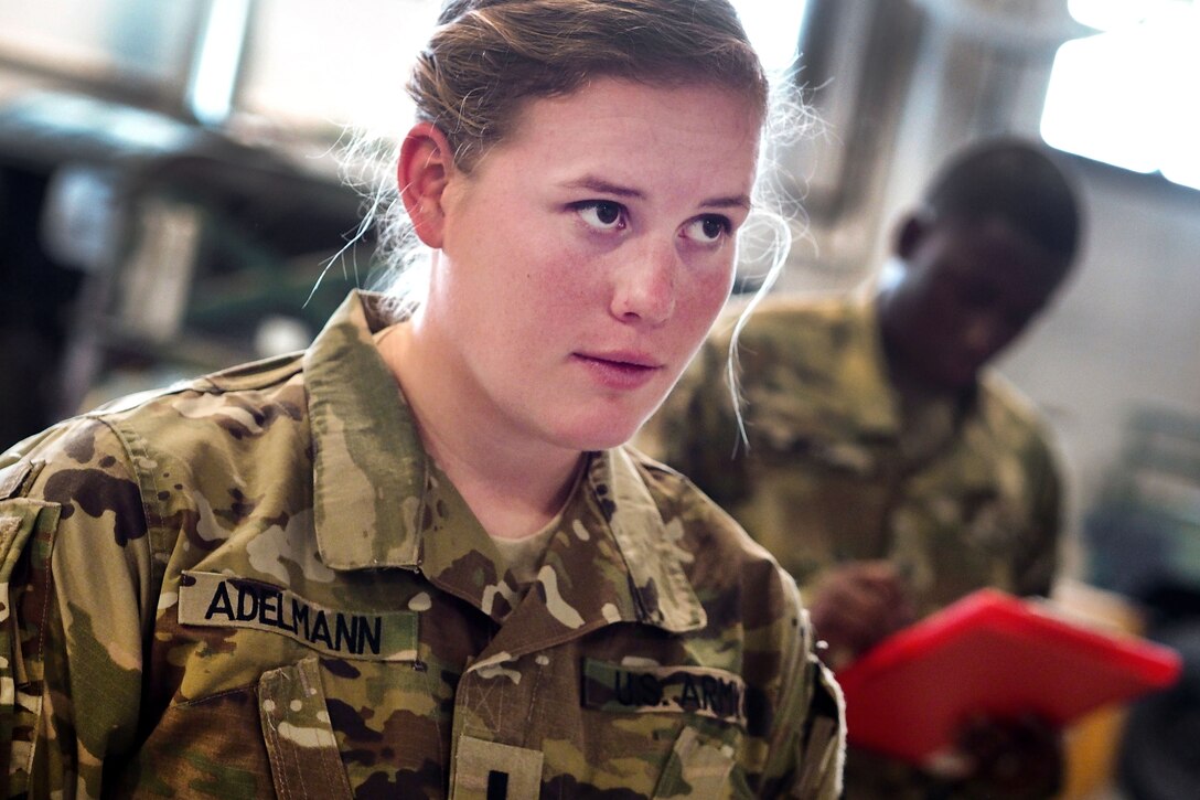 Army 1st Lt. Emily Adelmann receives instructions from a U.S. Army Pathfinder School instructor during slingload operations training at Joint Base Elmendorf-Richardson, Alaska, May 18, 2016. Adelmann is assigned to the 25th Infantry Division’s Company C, 25th Brigade Support Battalion, 1st Stryker Brigade Combat Team. Air Force photo by Justin Connaher