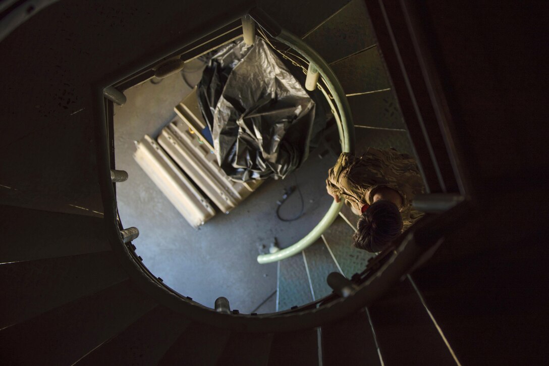 Air Force Airman 1st Class Angelena Legate walks down the staircase inside an observation tower at Bagram Airfield, Afghanistan, May 16, 2016. Legate is a weather forecaster assigned to the 455th Expeditionary Operations Support Squadron. Members of the squadron provide weather forecasts for aircrews, allowing flying units to plan and adjust mission requirements accordingly. Air Force photo by Senior Airman Justyn M. Freeman