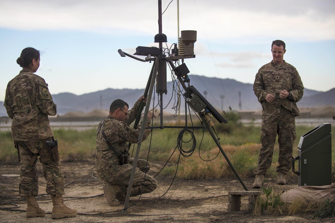 From left, Air Force Staff Sgt. Jennifer Palacios, Tech. Sgt. Heinz Disch and 1st Lt. Justin D'olimpio conduct an inspection on a tactical meteorological observation system at Bagram Airfield, Afghanistan, May 16, 2016. Palacios and Disch are weather forecasters and D'olimpio is weather flight commander of the 455th Expeditionary Operations Support Squadron. The system collects weather data including wind speed and direction, temperature, humidity, cloud height, precipitation and lightning. Air Force photo by Senior Airman Justyn M. Freeman