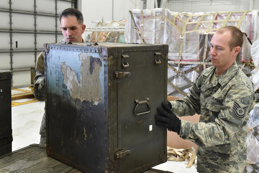 Senior Airman Ryan Rathburn, cargo unit deployment manager for the 76th Aerial Port Squadron, and Tech. Sgt. Joe Rinehart, an air transportation specialist for the 76th Aerial Port Squadron, load a cargo pallet here, May 15, 2016. Rathburn and Rinehart competed in the 2nd annual 76th Aerial Port Squadron Rodeo which tested the abilities of eight teams over the course of three days. The competition involves everything from pallet building and aircraft loading to a 100-question multiple choice test over aerial port information and generalized Air Force information. (U.S. Air Force photo/Tech. Sgt. James Brock)