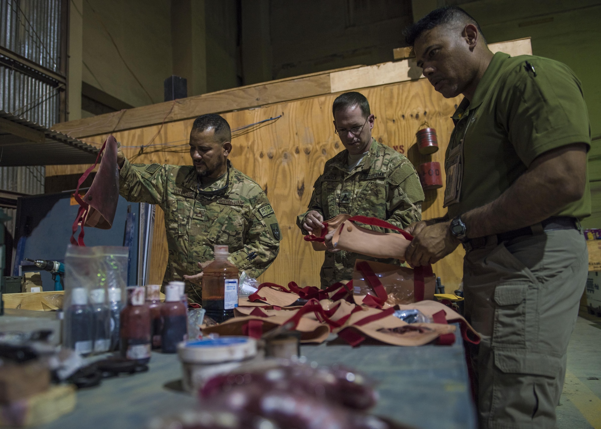 Department of Defense civilians arrange their medical moulage table to prepare for the mass casualty exercise held by the 455th Expeditionary Medical Group, at Bagram Airfield, Afghanistan, May 21, 2016. The application of moulage to Airmen provides a sense of realism in exercises that medics and first responders may encounter in real-world accidents. (U.S. Air Force photo by Senior Airman Justyn M. Freeman)