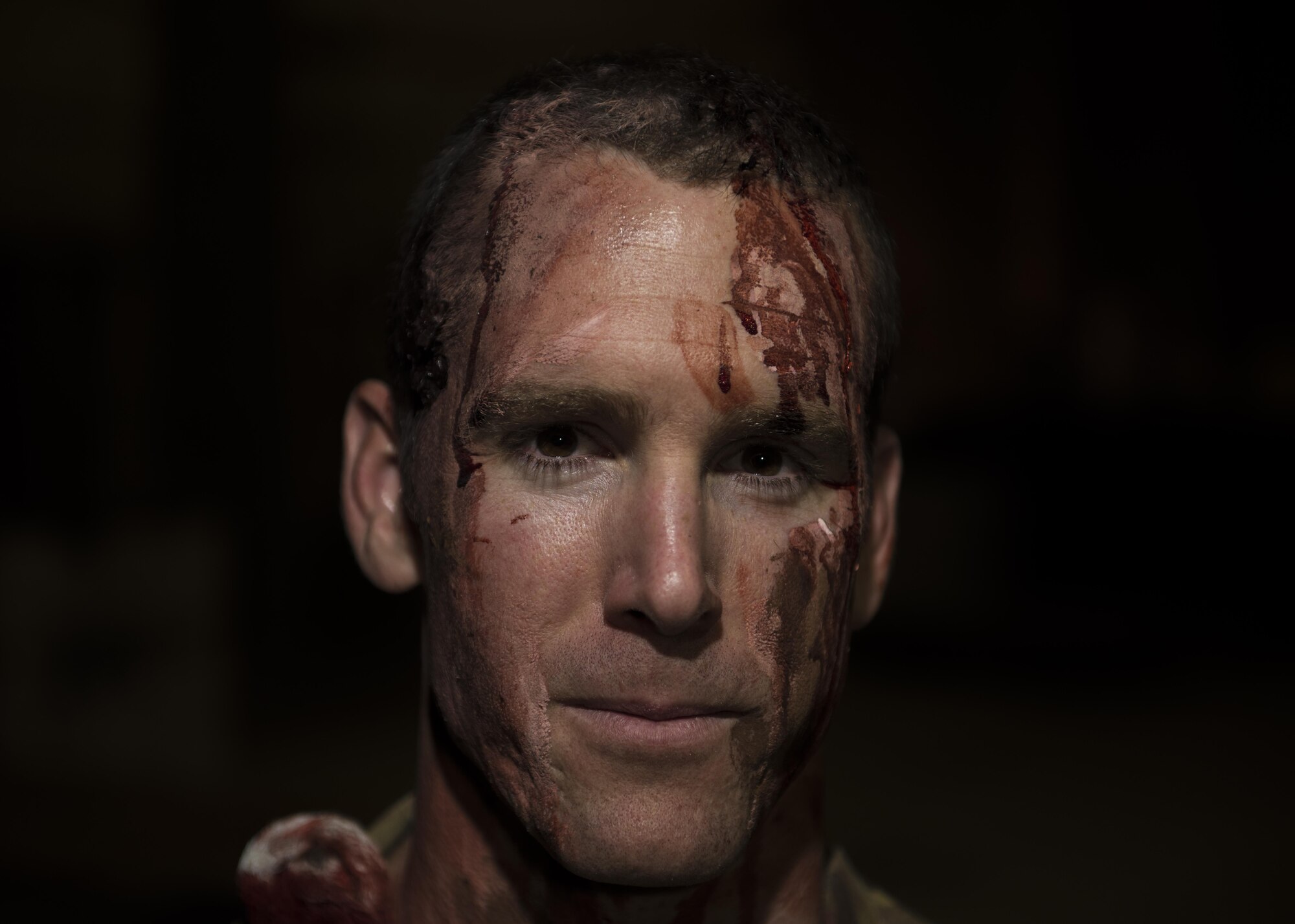 Staff Sgt. Mark Wolford, 455th Expeditionary Logistics Readiness Squadron CENTCOM Materiel Recovery Element vehicle mechanic, participates as a volunteer in a mass casualty exercise at Bagram Airfield, Afghanistan, May 21, 2016. The application of moulage to Airmen provides a sense of realism in exercises that medics and first responders may encounter in real-world accidents. (U.S. Air Force photo by Senior Airman Justyn M. Freeman)
