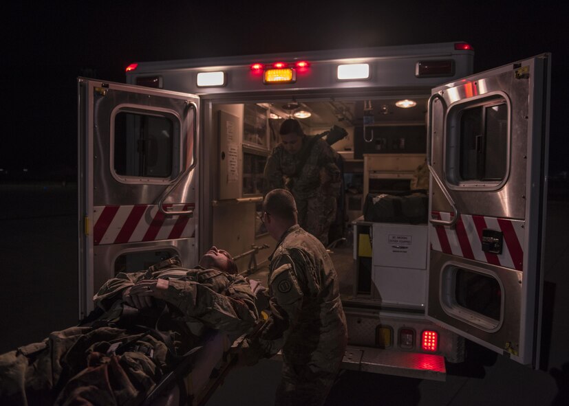 Airmen and soldiers work side by side to get an injured Airmen in an ambulance as they participate in a mass casualty exercise at Bagram Airfield, Afghanistan, May 21, 2016. These exercises are conducted to ensure that first responders are prepared to react to an accident or emergency. (U.S. Air Force photo by Senior Airman Justyn M. Freeman)
