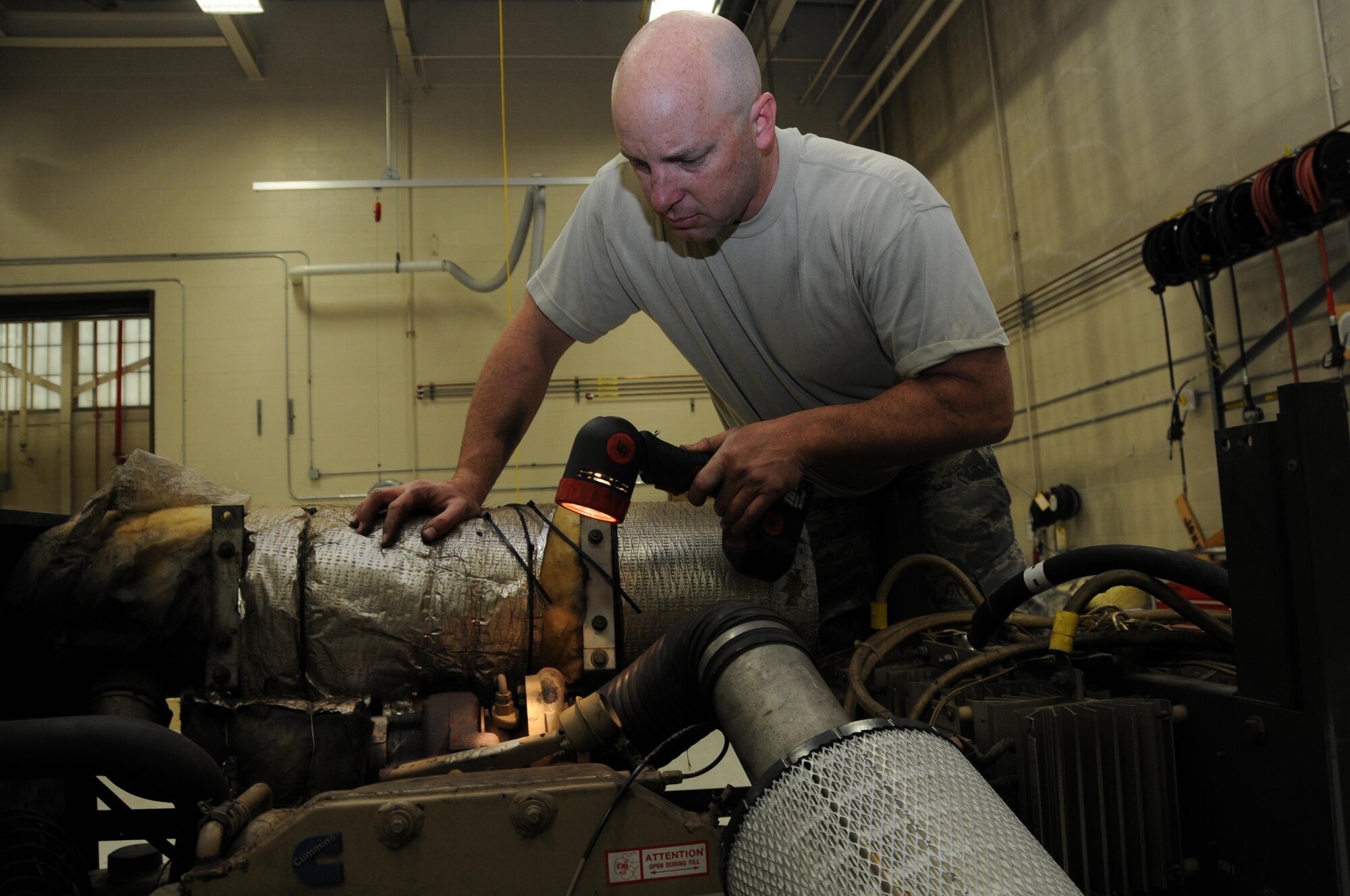 Staff Sgt. Bryon Sinclair, an aerospace ground equipment journeyman with the 910th Maintenance Squadron, looks for an oil leak on a B809 generator, here May 15, 2016. The B809 generator is used for ground power on C-130 Hercules aircraft. (U. S. Air Force photo/Tech. Sgt. Rick Lisum)