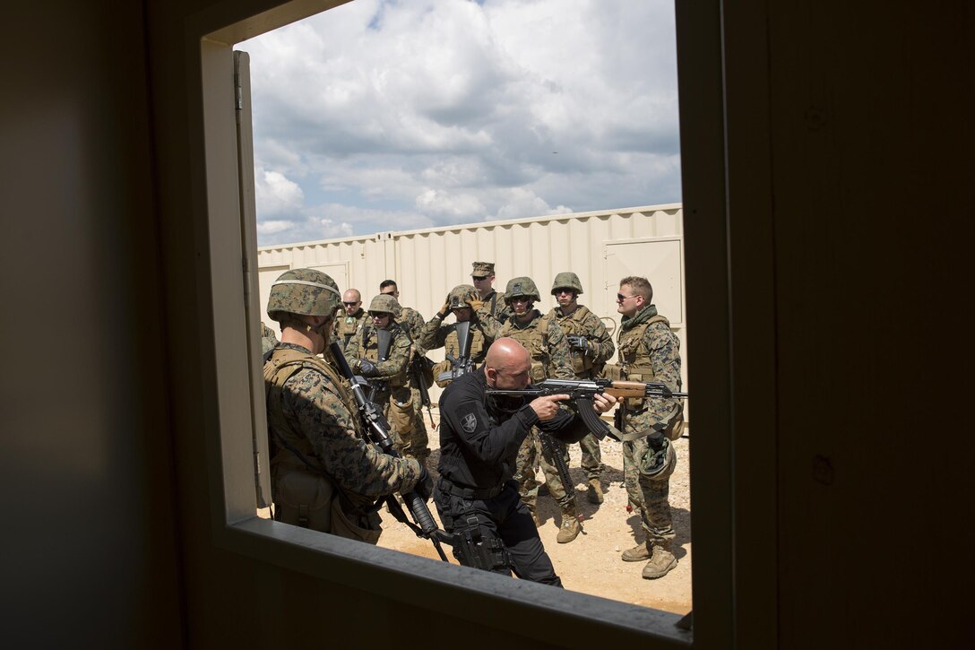 Reserve Marines with 4th Law Enforcement Battalion, Force Headquarters Group, Marine Forces Reserve, receive a class on room clearing tactics during exercise Platinum Wolf 2016 at Peacekeeping Operations Training Center South Base, Bujanovac, Serbia, May 18, 2016. The Marines are working with the partner nations of Bosnia, Bulgaria, Macedonia, Montenegro, Slovenia and Serbia to hone their skills in peacekeeping operations and non-lethal weapons systems. The partner nations are also focusing on sharing new tactics and techniques to improve their ability to work together.