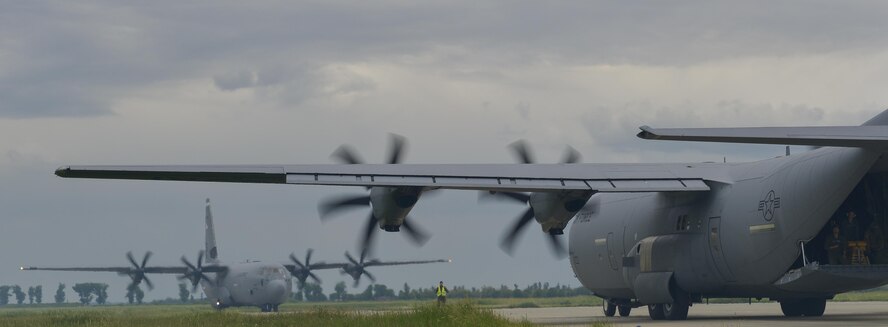 Romanian Airmen jump out of a C-130J Super Hercules during an airfield seizure operation for Exercise Carpathian Spring May 18, 2016, at Romania. The airfield seizure operation demonstrated the shared commitment and close cooperation between the U.S. and its NATO allies on countering a range of regional and global threats. (U.S. Air Force photo/Airman 1st Class Lane T. Plummer)
