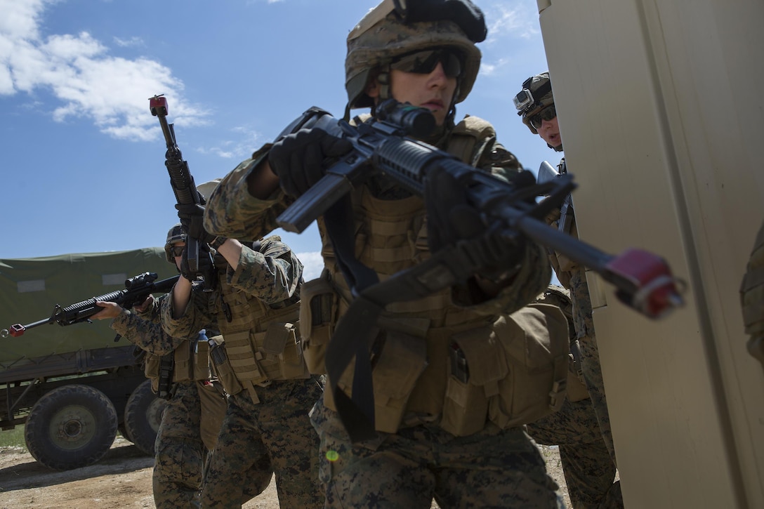 Reserve Marines with 4th Law Enforcement Battalion, Force Headquarters Group, Marine Forces Reserve, prepare to clear a house during exercise Platinum Wolf 2016 at Peacekeeping Operations Training Center South Base, Bujanovac, Serbia, May 18, 2016. The Marines are working with the partner nations of Bosnia, Bulgaria, Macedonia, Montenegro, Slovenia and Serbia to hone their skills in peacekeeping operations and non-lethal weapons systems. The partnering nations are also focusing on sharing new tactics and techniques to improve their ability to work together.