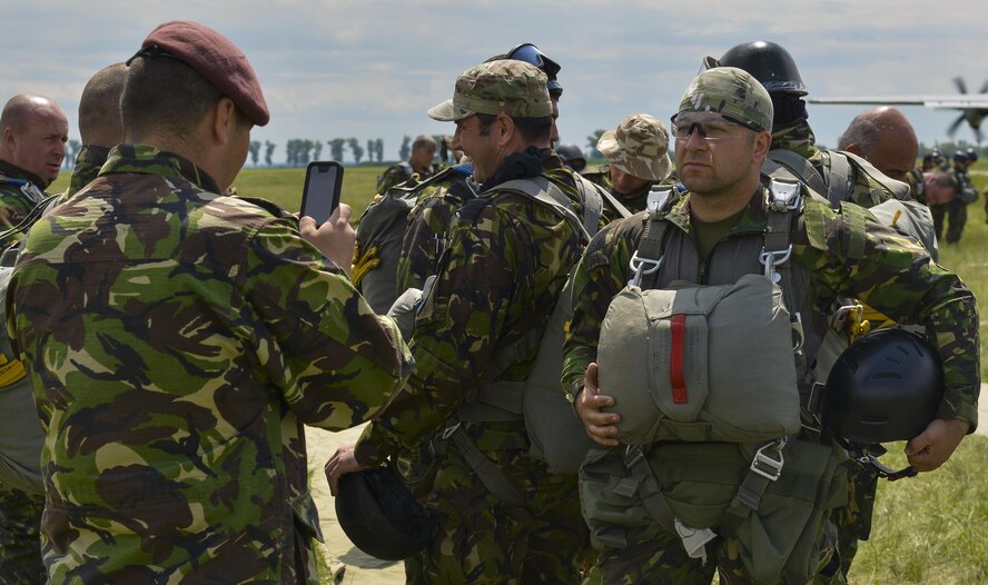 Romanian Airmen take photos of each other as they prepare to board a C-130J Super Hercules during Exercise Carpathian Spring May 18, 2016, at Romania. The airfield seizure operation demonstrated the shared commitment and close cooperation between the U.S. and its NATO allies on countering a range of regional and global threats. (U.S. Air Force photo/Airman 1st Class Lane T. Plummer)