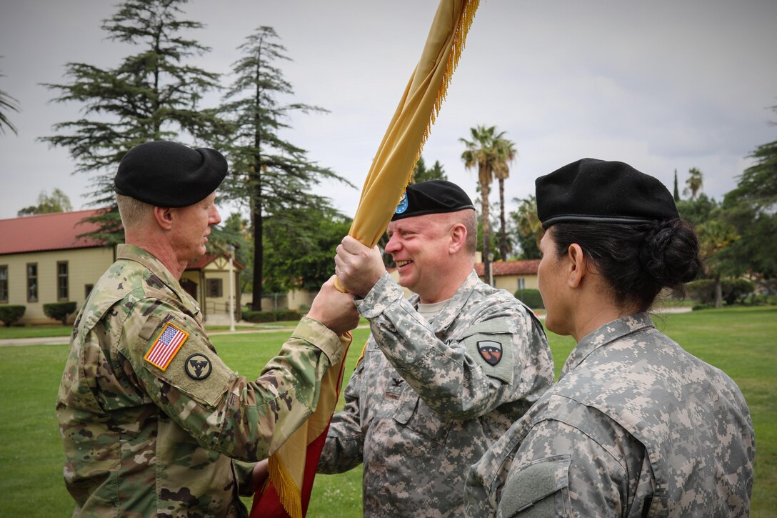 Brig. Gen. David Elwell, Commanding General, 311th Sustainment Command (Expeditionary), passes the colors to Col. Jon Blatt during the 304th Sustainment Brigade's Change of Command Ceremony, March Air Reserve Base, Riverside, Calif., May 15, 2016. (Photo courtesy of Staff Sgt. Ailid Beckstrom, 304th SB)