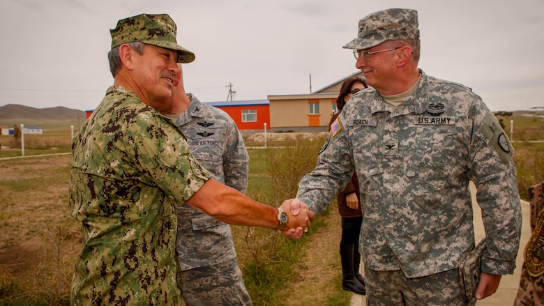 U.S. Navy Adm. Harry B. Harris, commander, U.S. Pacific Command, greets U.S. Army Col. Jeffrey Roach, commander, 38th Troop Command, before the Khaan Quest 2016 opening ceremony at the Five Hills Training Area, Mongolia, May 22, 2016. Khaan Quest is an annual, multinational peacekeeping operations exercise conducted in Mongolia and is the capstone exercise for this year's United Nations Global Peace Operations Initiative program. 