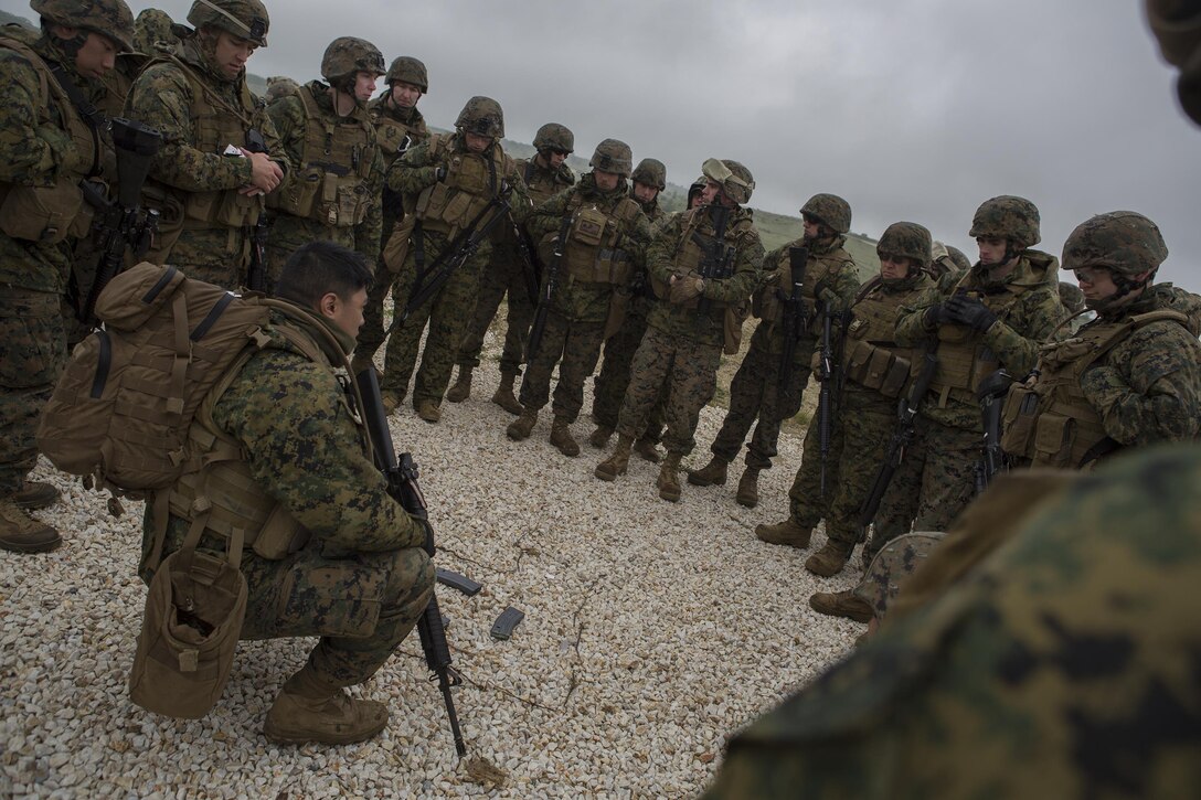 Reserve Marines with 4th Law Enforcement Battalion, Force Headquarters Group, Marine Forces Reserve, review a terrain map before heading out on a patrol during exercise Platinum Wolf 2016 at Peacekeeping Operations Training Center South Base, Bujanovac, Serbia, May 16, 2016. The Marines are working with the partner nations of Bosnia, Bulgaria, Macedonia, Montenegro, Slovenia and Serbia to share new ideas, build interoperability, and master peacekeeping operations.