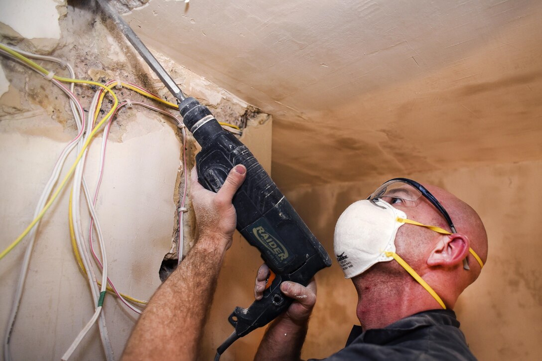Air Force Staff Sgt. Mark Wilkes drills a hole in a ceiling for wiring during a U.S. European Command humanitarian civic assistance project in Yerevan, Armenia, May 13, 2016. Wilkes is an electrician assigned to the Georgia Air National Guard’s 116th Civil Engineer Squadron. Air National Guard photo by Master Sgt. Regina Young