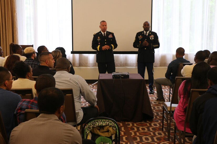 Army Reserve Brig. Gen. Vincent B. Barker, commanding general of the 310th Sustainment Command (Expeditionary) (left), and Command Sgt. Maj. Levi G. Maynard, senior enlisted advisor of the 310th Sustainment Command (Expeditionary) (right), speak to the Soldiers and Family members of the 313th Movement Control Battalion, headquartered in Baltimore, Md., during the yellow ribbon reintegration program event at the Tyson’s Corner, Va. Sheraton Hotel, May 6-8, 2016. The event came prior to deployment of the Army Reserve Soldiers of the 313th Movement Control Battalion, and was designed to prepare airmen and their spouses for stresses and possible needs that can arise during a deployment.