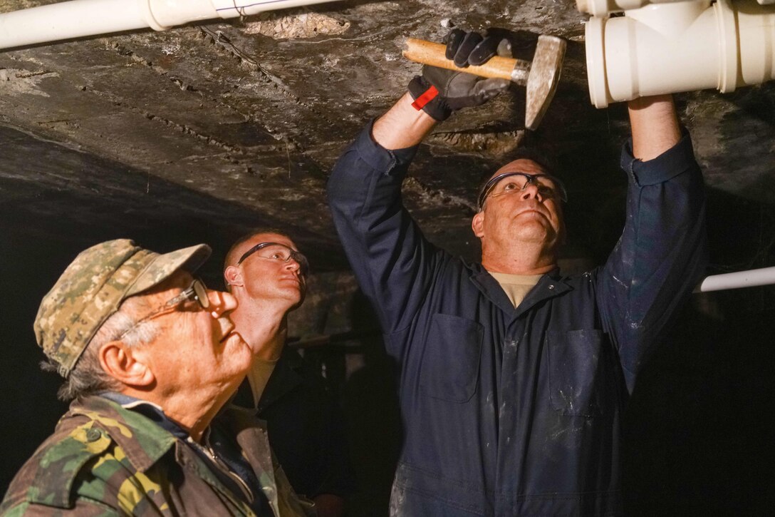 Air Force Master Sgt. John Birdsong, right, and Tech. Sgt. Randy Daniels, center, work with an Armenian plumber to repair pipes in the basement of a care facility for the elderly during a U.S. European Command humanitarian project in Yerevan, Armenia, May 13, 2016. Birdsong and Daniels are assigned to the Georgia Air National Guard’s 116th Civil Engineer Squadron. Air National Guard photo by Senior Master Sgt. Roger Parsons