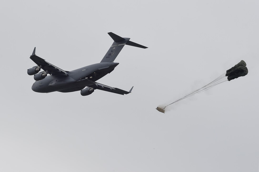 An Air Force C-17 Globemaster III drops a training resupply bundle during joint airborne and air transportability training at Joint Base Elmendorf-Richardson, Alaska, May 19, 2016. Air Force photo by Alejandro Pena