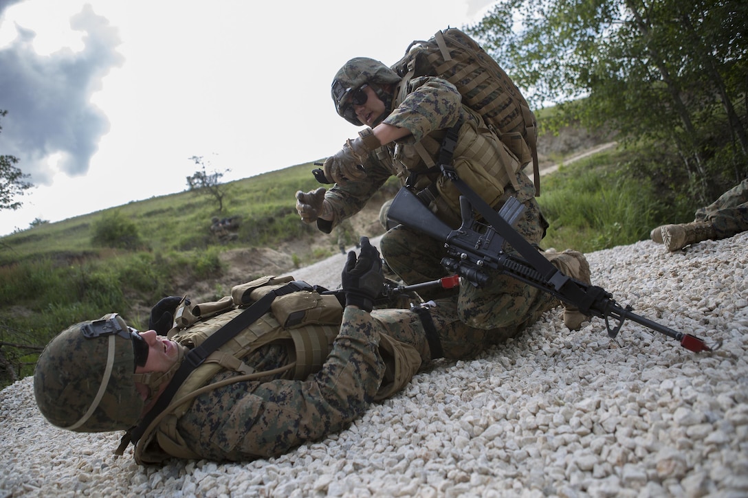 HM3 Ryan Loomis, a hospital corpsman with 4th Law Enforcement Battalion, Force Headquarters Group, Marine Forces Reserve, applies a tourniquet to a simulated casualty during exercise Platinum Wolf 2016 at Peacekeeping Operations Training Center South Base, Bujanovac, Serbia, May 19, 2016. The Marines are working with partner nations of Bosnia, Bulgaria, Macedonia, Montenegro, Slovenia and Serbia during the final field exercise where they master patrols, military operation urban terrain training, and building their interoperability.