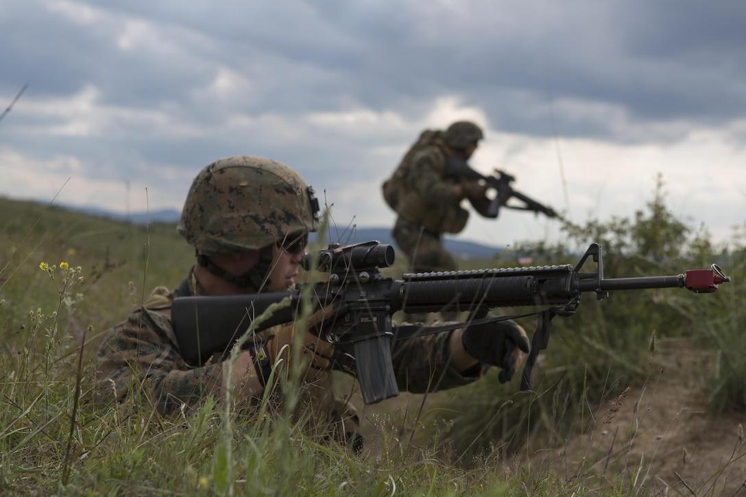 Cpl. Jacob Granado, military police, with 4th Law Enforcement Battalion, Force Headquarters Group, Marine Forces Reserve, prepares to rush forward to engage a simulated enemy during exercise Platinum Wolf 2016 at Peacekeeping Operations Training Center South Base, Bujanovac, Serbia, May 19, 2016. The Marines are working with the partner nations of Bosnia, Bulgaria, Macedonia, Montenegro, Slovenia and Serbia during the final field exercise where they master patrols, military operation urban terrain training, and work on building their interoperability.