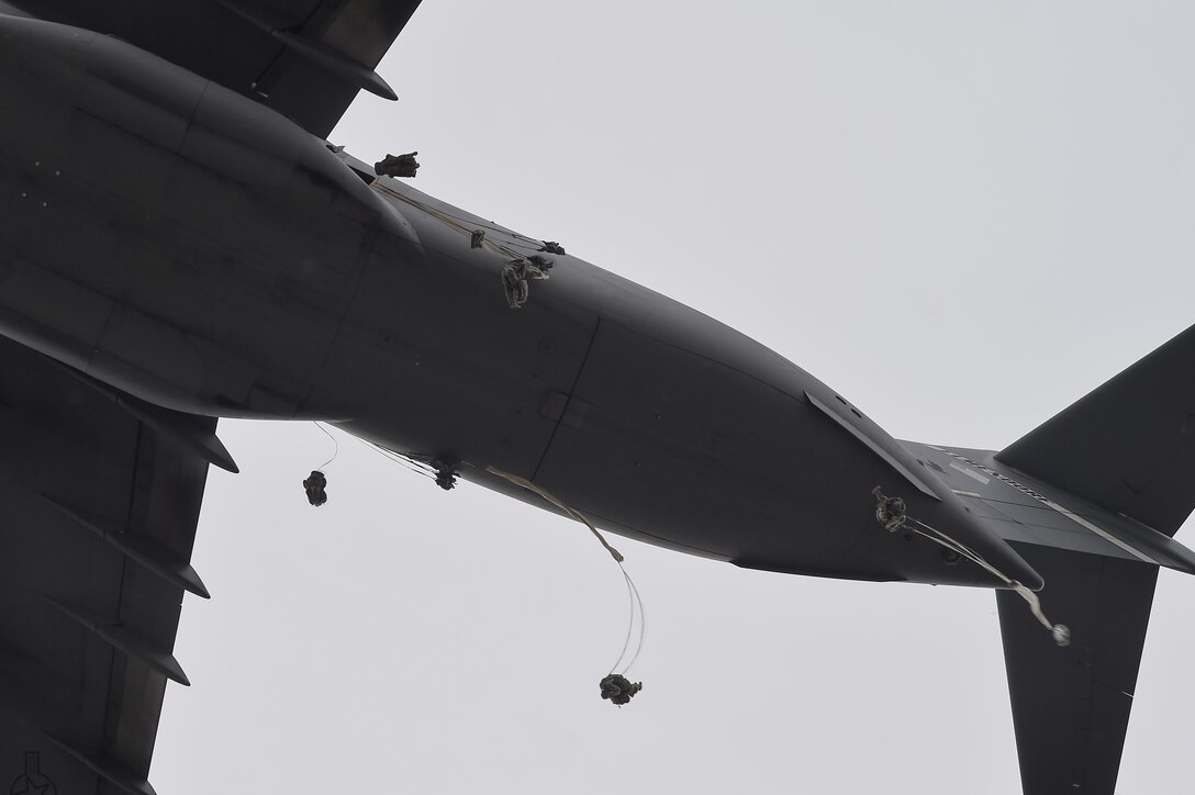 Paratroopers jump from an Air Force C-17 Globemaster III aircraft during joint airborne and air transportability training at Joint Base Elmendorf-Richardson, Alaska, May 19, 2016. Air Force photo by Alejandro Pena