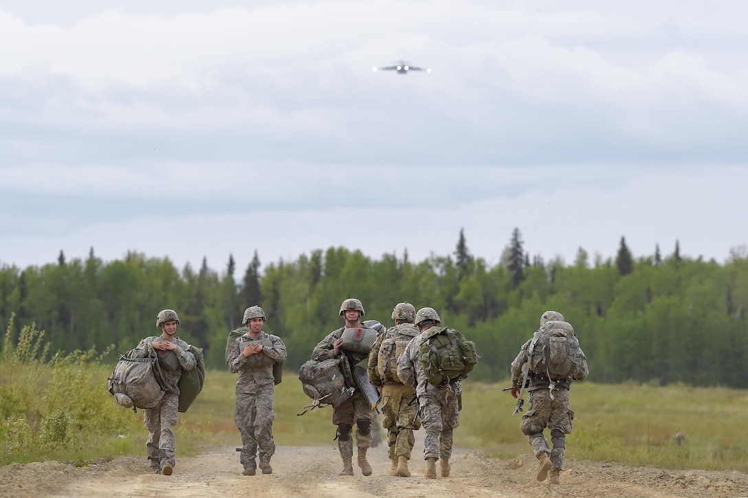 Paratroopers proceed to a rally and collection point after participating in joint airborne and air transportability training at Malemute drop zone at Joint Base Elmendorf-Richardson, Alaska, May 19, 2016. Air Force photo by Alejandro Pena