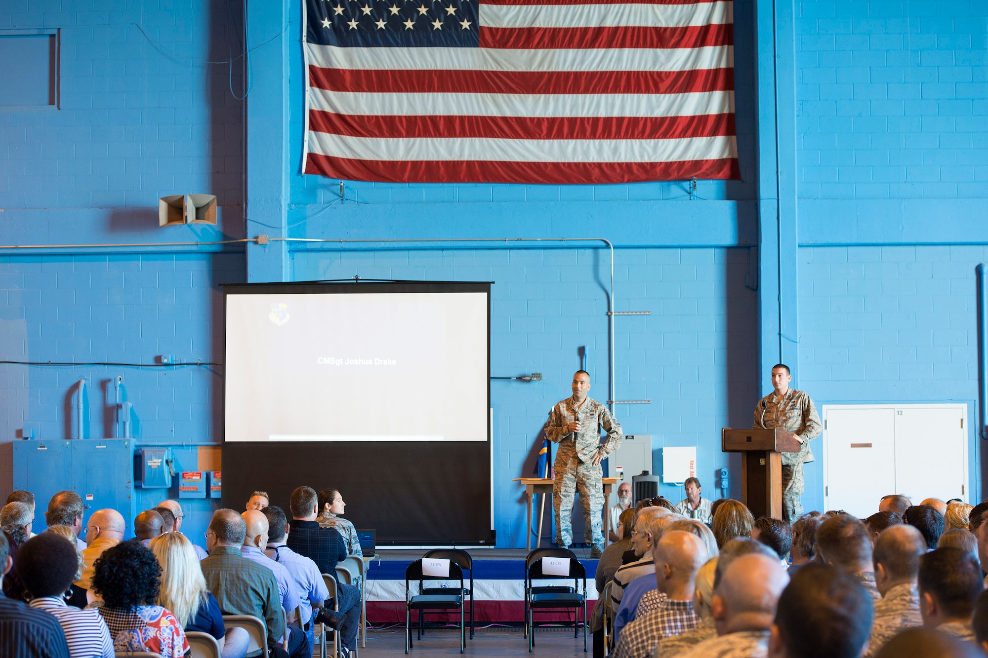 Chief Master Sgt. Joshua Drake, 45th Mission Support Group Superintendent, recognizes the hard work and dedication of his unit during their group’s Commander’s Call April 20, 2016 at Cape Canaveral Air Force Station. The group's objective was to gather together in a location where the 45th Space Wing's launch operations happen to get an up close and personal with the mission and history of the wing in an interactive, informative way. The 45th MSG's five squadrons provide total customer support for the world's busiest spaceport, assuring success of launch, range and expeditionary operations. Also, the 45th MSG Det.1 is responsible for the day-to-day operations CCAFS. (U.S. Air Force photo by Matthew Jurgens/Released) 
