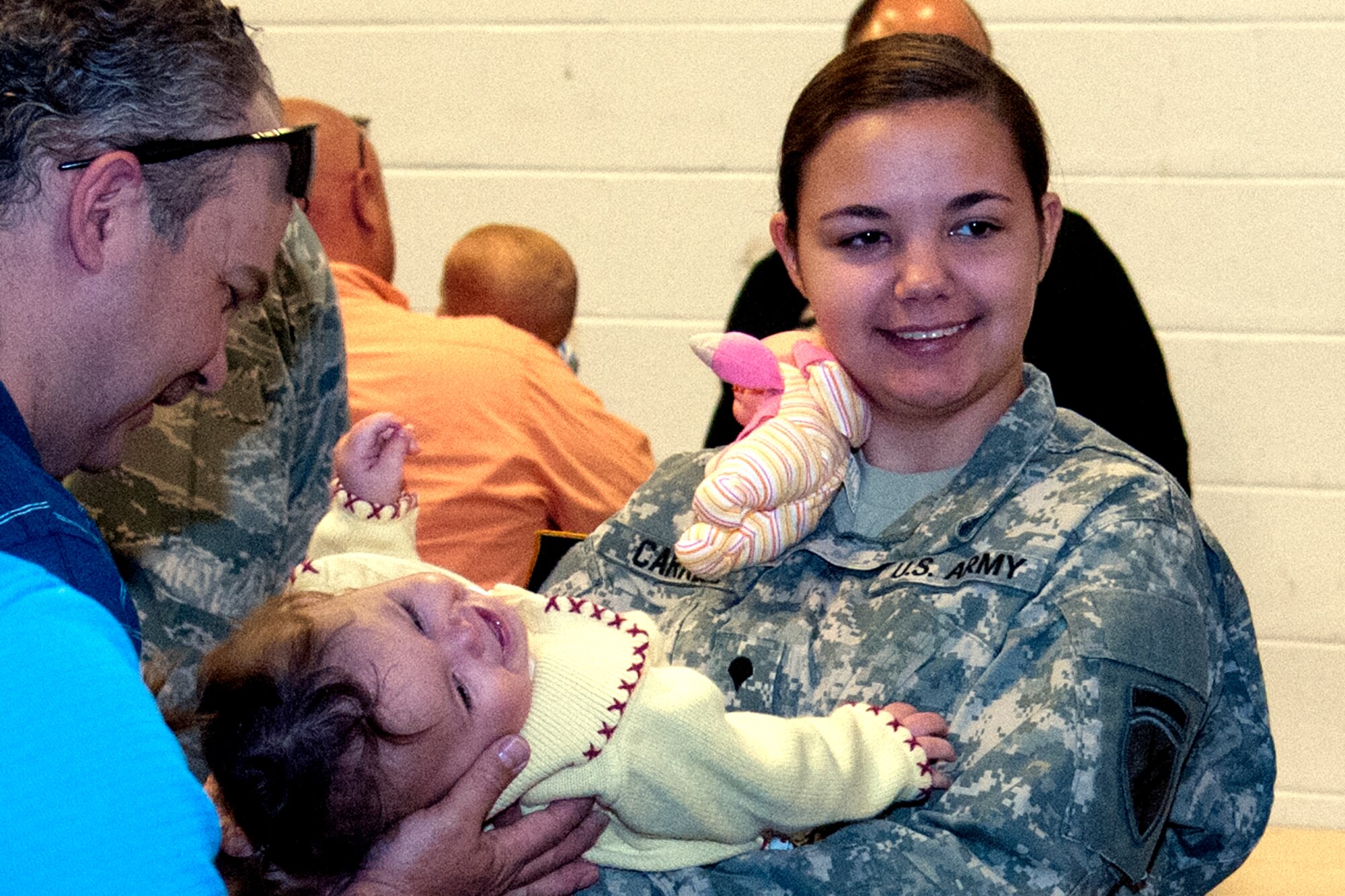 Spc. Ashley Carrell, 316th Psychological Operations Company, says goodbye to her family before leaving for a deployment May 7, 2016 at Grissom Air Reserve Base, Ind. Carrell was one of several soldiers from the 316th Psyop Co. preparing to deploy to Africa for several months. (U.S. Air Force photo/Senior Airman Dakota Bergl) 
