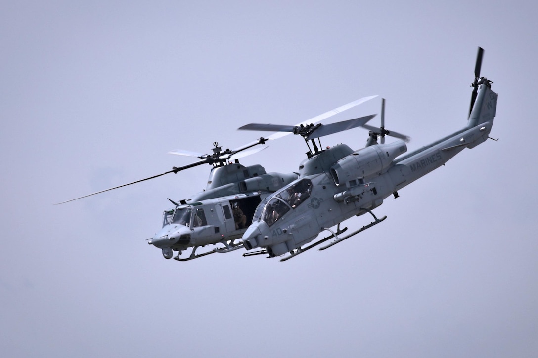 A Marine Corps UH-1 Venom, left, and AH-1 Super Cobra fly during the Power in the Pines Open House and Air Show at Joint Base McGuire-Dix-Lakehurst, N.J., May 14, 2016. The pilots and helicopters are assigned to Marine Aircraft Group 49. Air National Guard photo by Tech. Sgt. Matt Hecht