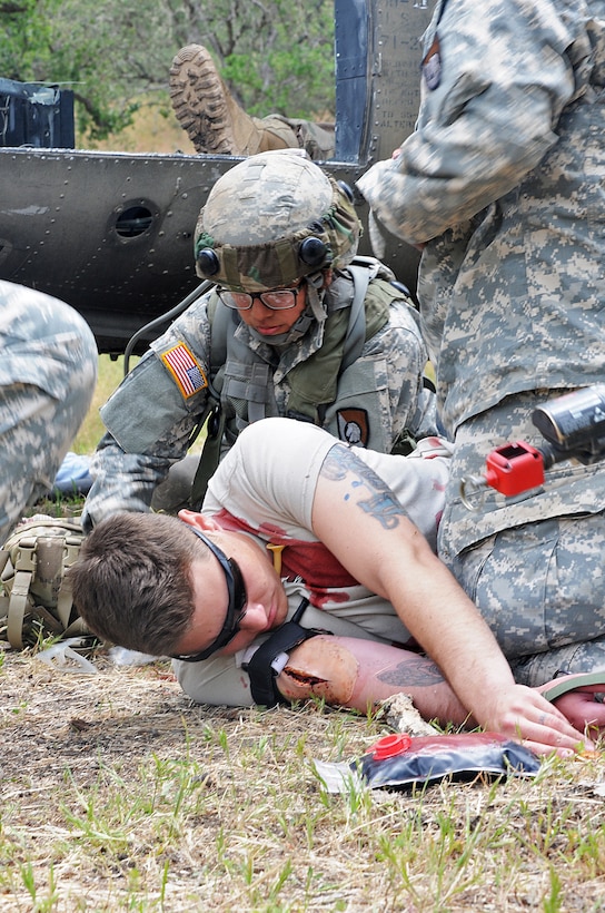JOLON, Calif. – Spc. Jacob Duncan (laying), an Opposing Forces casualty and combat medic with the 570th Sapper Company, 864th Engineer Battalion, 555th Engineer Brigade of Joint Base Lewis-McChord, Wash., simulates a surviving casualty of a helicopter crash, is evaluated by Soldiers during a route-clearance and medical training exercise at Fort Hunter Liggett, Calif., May 6. (U.S. Army photo by Sgt. Kimberly Browne 350th Public Affairs Detachment)