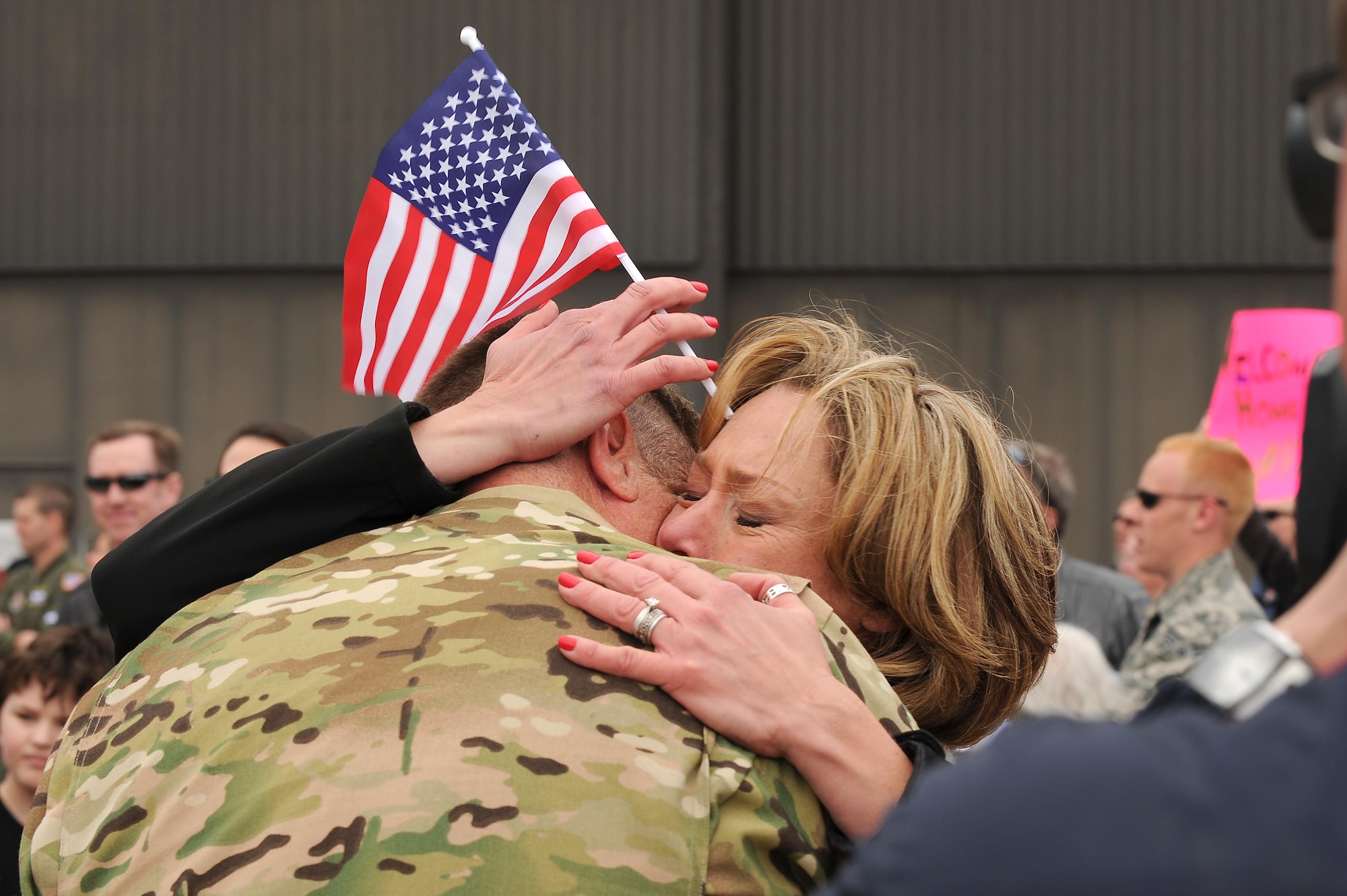 A spouse embraces her husband after he returned from a four-month deployment on May 18, 2016 at Peterson Air Force Base, Colo. Approximately 150 Air Force Reservists and four C-130 cargo aircraft from the 302nd Airlift Wing returned home from Al Udeid Air Base, Qatar, in support of Operations Freedom’s Sentinel and Inherent Resolve. While deployed, the Airmen provided critical C-130 airlift support to include airlift, airdrop and aeromedical evacuation to U.S. Central Command operations throughout Southwest Asia. The deployed members of the 302nd Maintenance Group provided aircraft maintenance support ensuring fully mission capable C-130s in Southwest Asia.  (U.S. Air Force photo/Staff Sgt. Amber Sorsek)